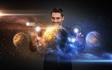 Image showing businessman with virtual planets and space