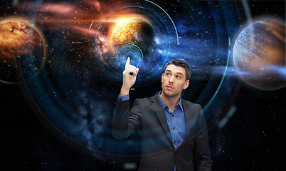 Image showing businessman with virtual planets and space