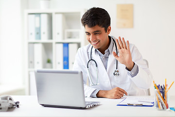 Image showing doctor having video conference on laptop at clinic