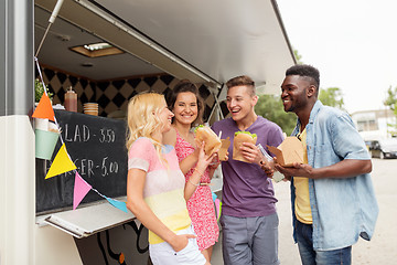 Image showing happy friends with drinks eating at food truck