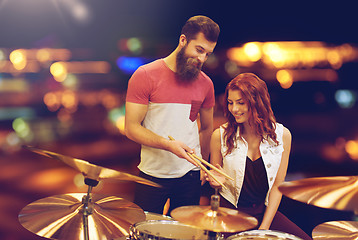 Image showing man and woman with drum kit at music store