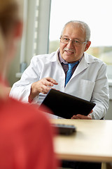 Image showing senior doctor and patient at womens health clinic