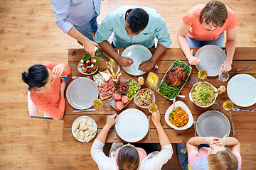 Image showing group of people eating at table with food
