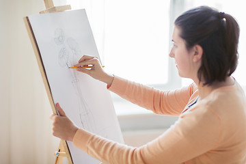 Image showing artist with pencil drawing picture at art studio