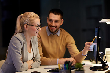 Image showing business team with computer working late at office