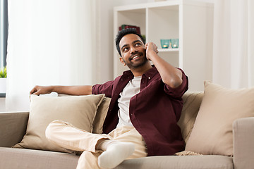 Image showing happy man calling on smartphone at home