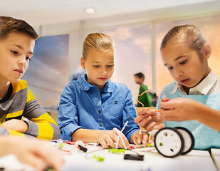 Image showing happy children building robots at robotics school