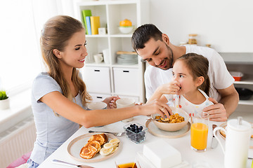 Image showing happy family having breakfast at home