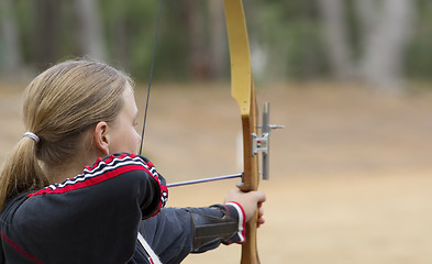 Image showing teenage girl doing archery