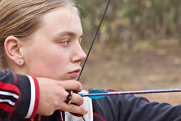 Image showing teenage girl doing archery