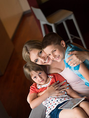 Image showing Young Family Using A Tablet To Make Future Plans