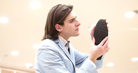 Image showing Man Chooses Shoes At Shoe Store