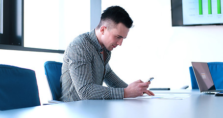 Image showing Senior businessman  using cell phone at  stratup office