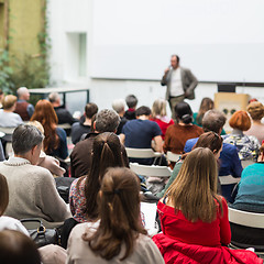 Image showing Man giving presentation in lecture hall at university.