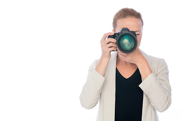 Image showing Woman photographer takes images with dslr camera