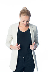 Image showing Casual, relaxed, business woman looking down, standing against white background.