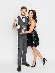 Image showing happy couple with champagne and glasses at party