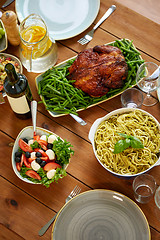 Image showing pasta, vegetable salad and roast chicken on table