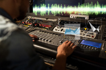 Image showing sound engineer at recording studio mixing console