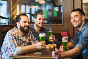 Image showing friends taking selfie with green beer at pub