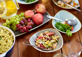 Image showing salad, fruits and pasta on wooden table