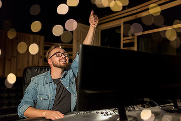 Image showing man at mixing console in music recording studio