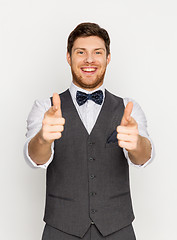 Image showing happy man in festive suit pointing in camera