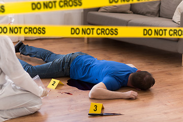 Image showing criminalist collecting evidence at crime scene