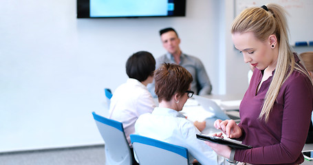 Image showing Pretty Businesswoman Using Tablet In Office Building during conf