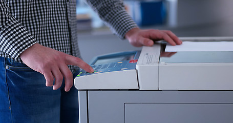 Image showing Male Assistant Using Copy Machine in modern office