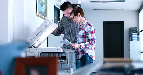 Image showing businesswoman with her assistant making copies of files