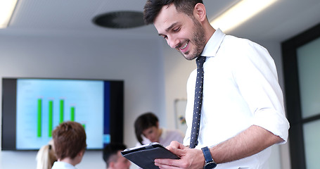 Image showing Businessman using tablet in modern office