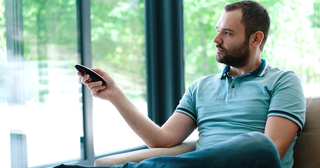 Image showing Happy Man Watching Television