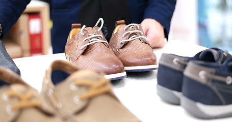 Image showing Man Chooses Shoes At Shoe Store