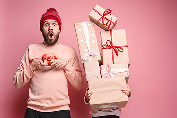 Image showing Portrait of a surprised little girl with her father holding a Christmas present