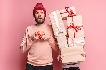 Image showing Portrait of a surprised little girl with her father holding a Christmas present