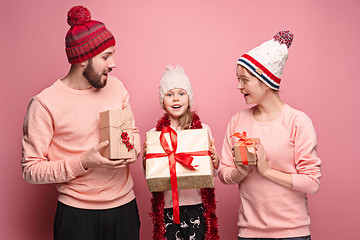 Image showing Father and mother give gifts to little daughter at studio