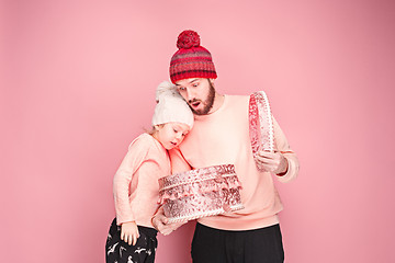 Image showing Portrait of a surprised little girl with her father holding a Christmas present