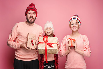 Image showing Father and mother give gifts to little daughter at studio