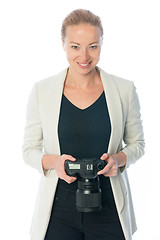 Image showing Woman photographer takes images with dslr camera