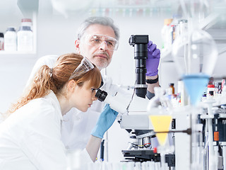 Image showing Health care researchers microscoping in scientific laboratory.