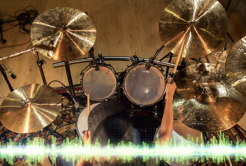 Image showing male musician playing drum kit at studio 