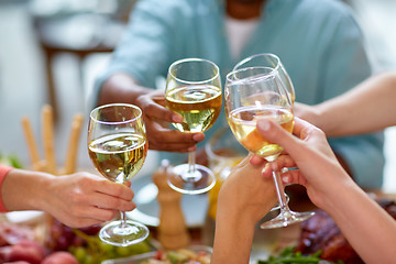 Image showing hands clinking wine glasses