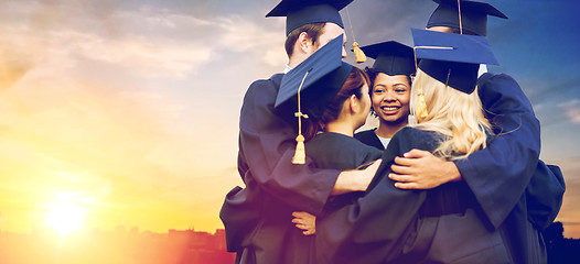 Image showing happy students or bachelors hugging