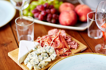 Image showing blue cheese and jamon ham on wooden table