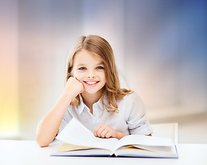 Image showing happy smiling student girl reading book