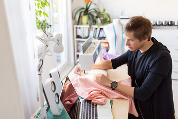 Image showing fashion designer with sewing machine working