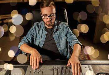 Image showing man at mixing console in music recording studio