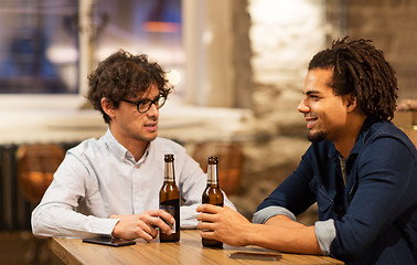 Image showing happy male friends drinking beer at bar or pub