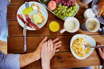 Image showing couple hands on table full of food